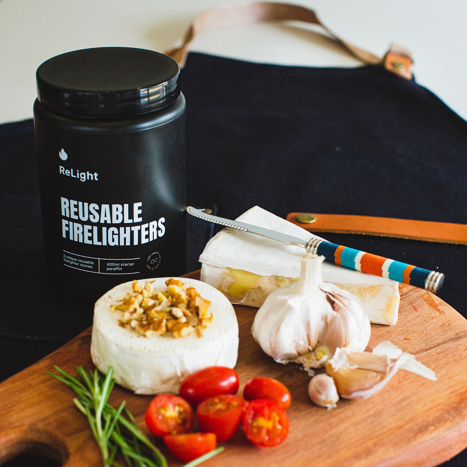 Mahlori Gatherings Box (Close up of Firelighter Bottle, Cheese Knife, Cheese Board on Apron)