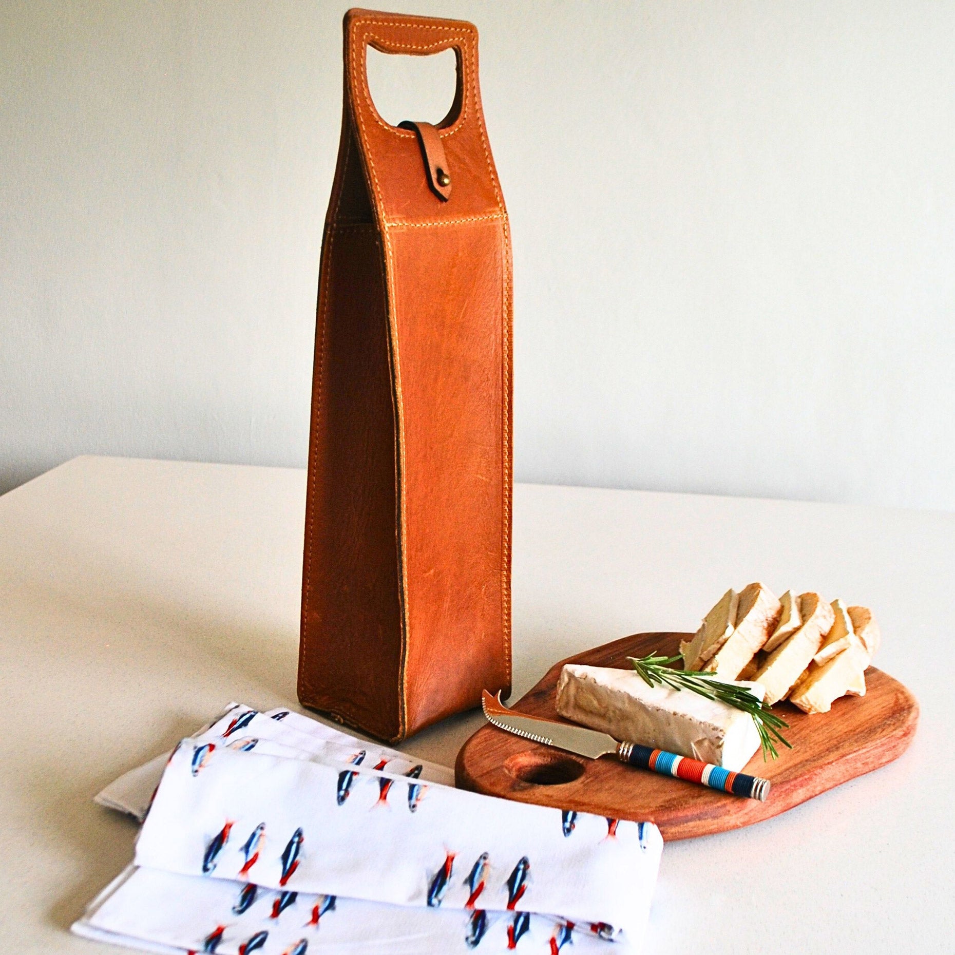 Umekela Essentials Box (Pieter de Jager Oblong Cheese Board, Pieter de Jager Leather Single Wine Carrier, PaulaG Cheese Knife Sea Boat Blue, Owl in the Moss Neon Napkins)