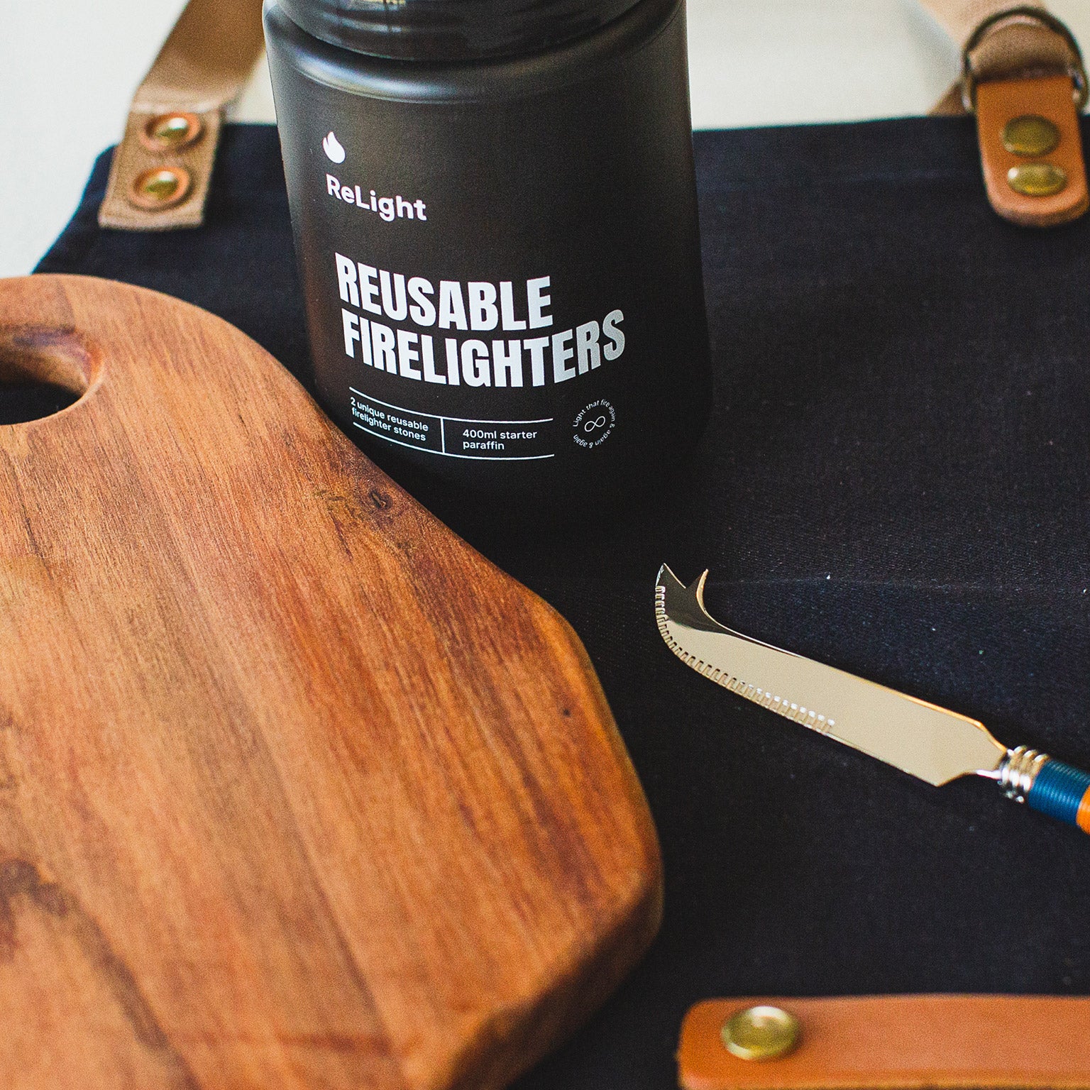 Mahlori Gatherings Box (Close up of Firelighters Bottle, Cheese Knife, Cheese Board and Apron)