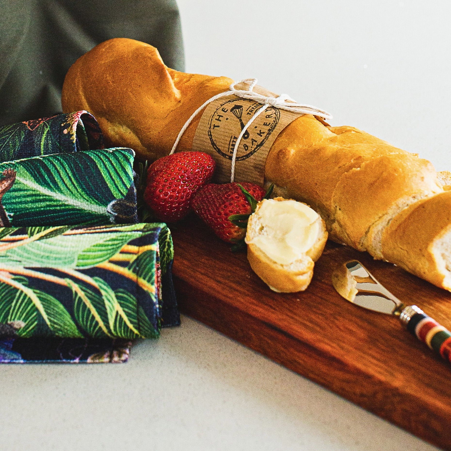 Thando Selection Box (Pieter de Jager Baguette Board, Cara Saven On the 6th Day Napkins, PaulaG Butter Knife Copper Black with Bread)